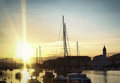 Boats in harbor at sunset