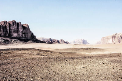 Scenic view of arid landscape against clear sky