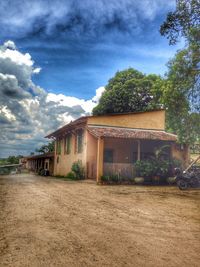 Houses against cloudy sky