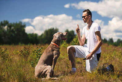 Woman with dog on field