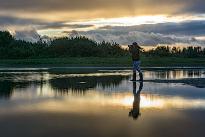 Scenic view of lake at sunset