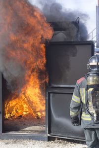 Rear view of firefighter working outdoors