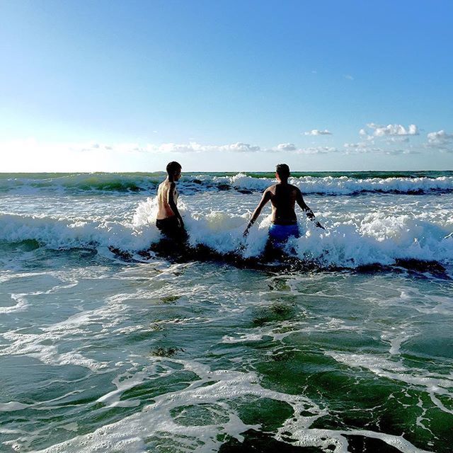 sea, water, horizon over water, leisure activity, lifestyles, vacations, wave, beach, sky, full length, enjoyment, shore, scenics, surf, beauty in nature, clear sky, nature, people