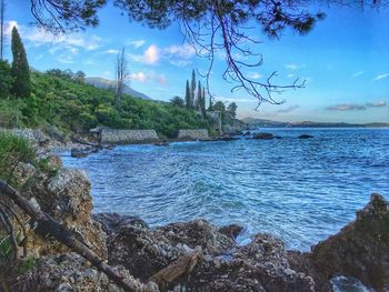Scenic view of calm lake against cloudy sky