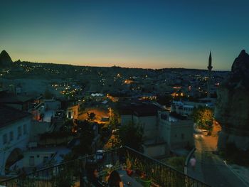 High angle view of illuminated buildings against sky at dusk