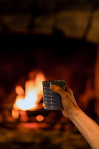Close-up of hand holding burning candle
