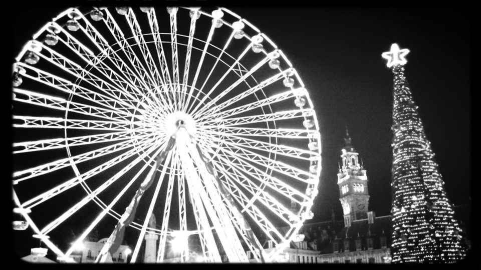 low angle view, arts culture and entertainment, amusement park, amusement park ride, ferris wheel, built structure, sky, night, metal, architecture, circle, illuminated, transfer print, outdoors, auto post production filter, no people, clear sky, metallic, travel destinations, silhouette