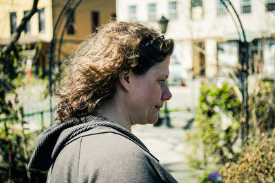 Portrait of young woman looking away outdoors
