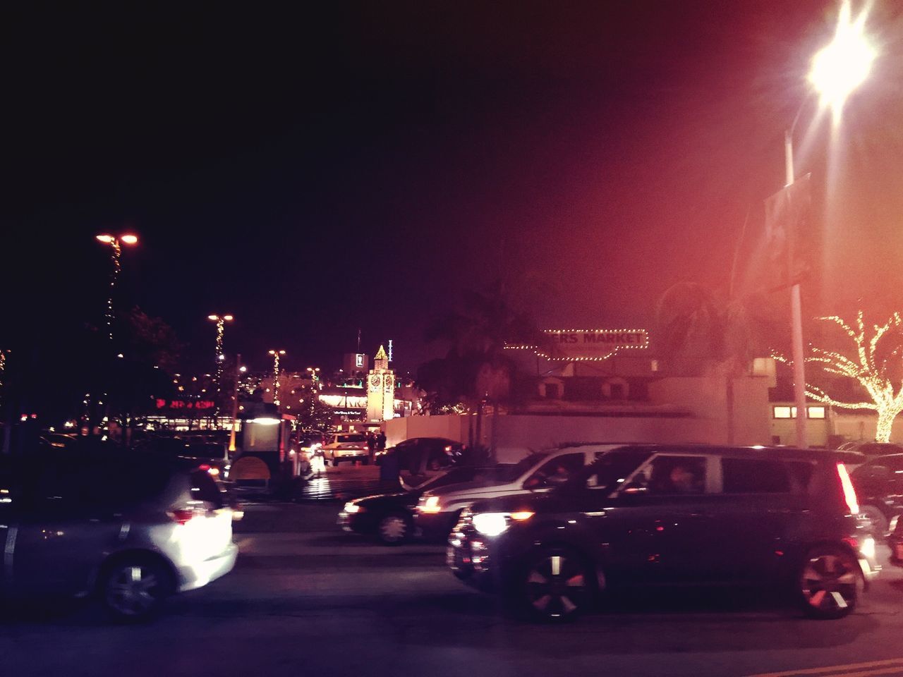 night, illuminated, land vehicle, car, building exterior, transportation, mode of transport, architecture, street, built structure, city, road, street light, copy space, clear sky, lens flare, parking, outdoors, city street, sky