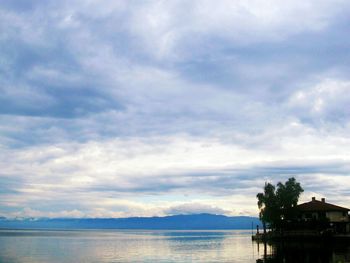 Scenic view of lake against cloudy sky