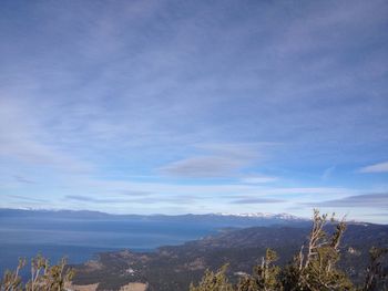 Scenic view of mountains against blue sky