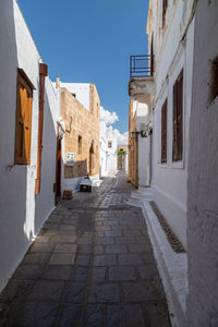 Narrow street with white houses in lindos on greek island rhodes