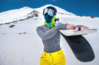 Full length of senior woman on snowcapped mountain