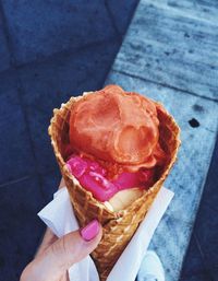 Cropped hand of woman holding ice cream cone