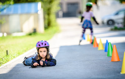 Portrait of smiling lying on road