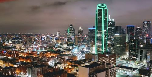 Illuminated cityscape against sky at night