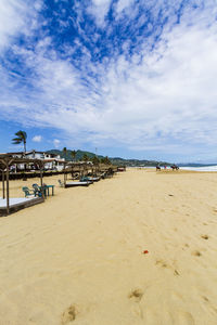 Scenic view of beach by sea against sky