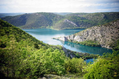 Scenic view of lake and mountains against sky