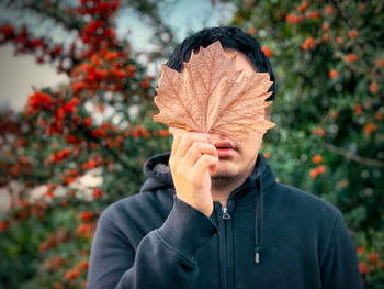 Portrait of a person standing on snow covered plants