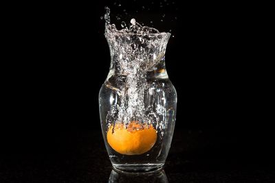 Close-up of water splashing against black background