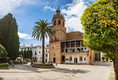 Panoramic view of buildings and trees against sky in city