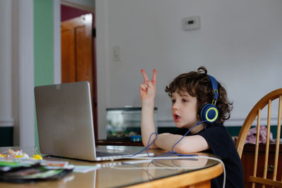 A young boy learning in front of a laptop