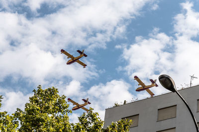 Low angle view of airplane flying against sky