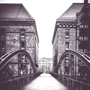 View of bridge and buildings against clear sky