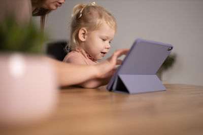 Young woman using laptop at table