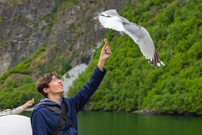 Full length of man flying over lake