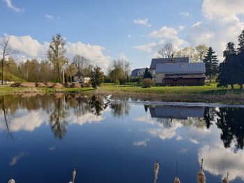 Scenic view of lake by building against sky