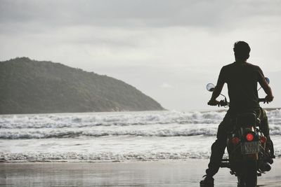 Rear view of man standing on beach