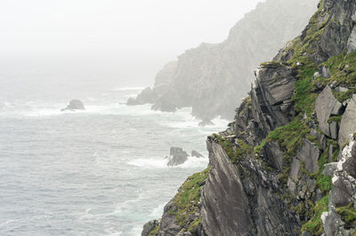 Scenic view of sea and mountain against sky