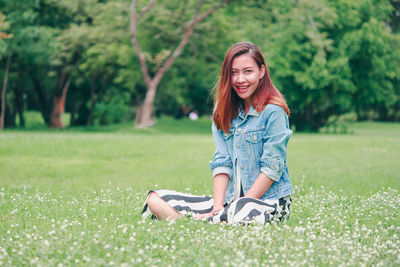 Portrait of smiling young woman on field