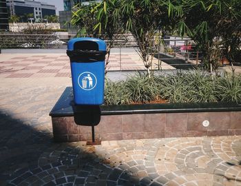 Blue garbage bin outside food court