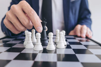 Midsection of man playing chess