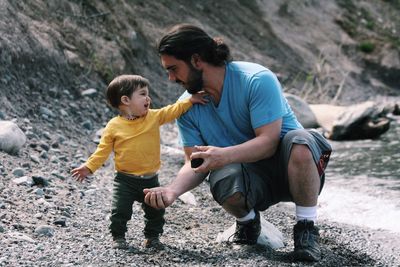 Cute boy playing with father 