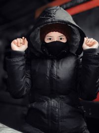 Close-up portrait of cute baby girl standing in snow