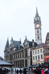 People in front of church against clear sky