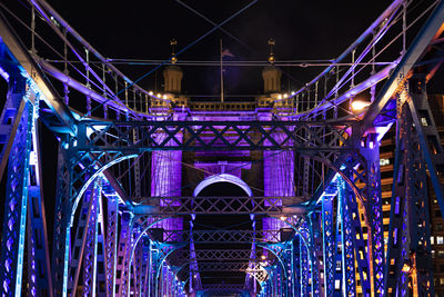 Low angle view of illuminated bridge at night