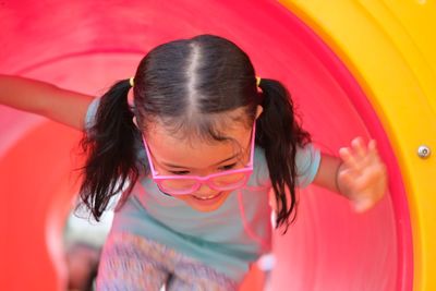 Close-up of girl playing in outdoors play equipment