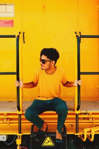 Side view of young man exercising in gym