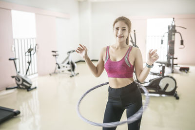 Portrait of young man standing against wall