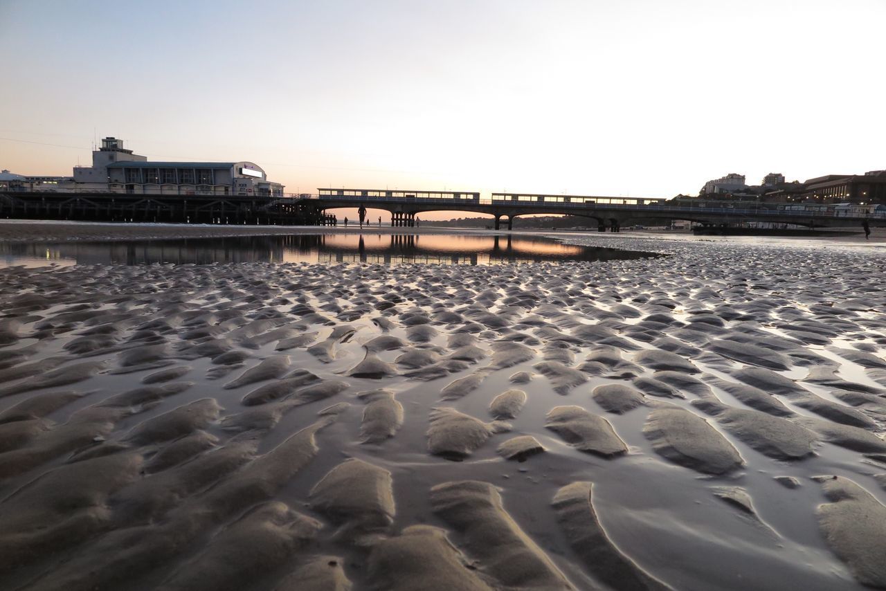 SURFACE LEVEL OF BEACH AGAINST SKY