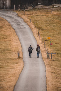 High angle view of people walking on footpath