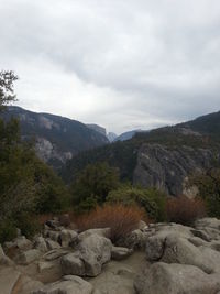 Scenic view of mountains against cloudy sky