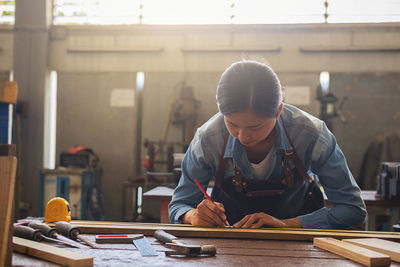 Carpenter working in carpentry workshop