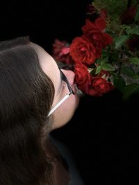 Close-up of woman holding rose at home