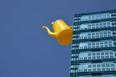  yellow jug hanging on blue crates