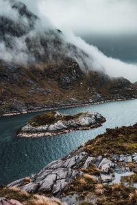 Scenic view of sea and mountain against sky